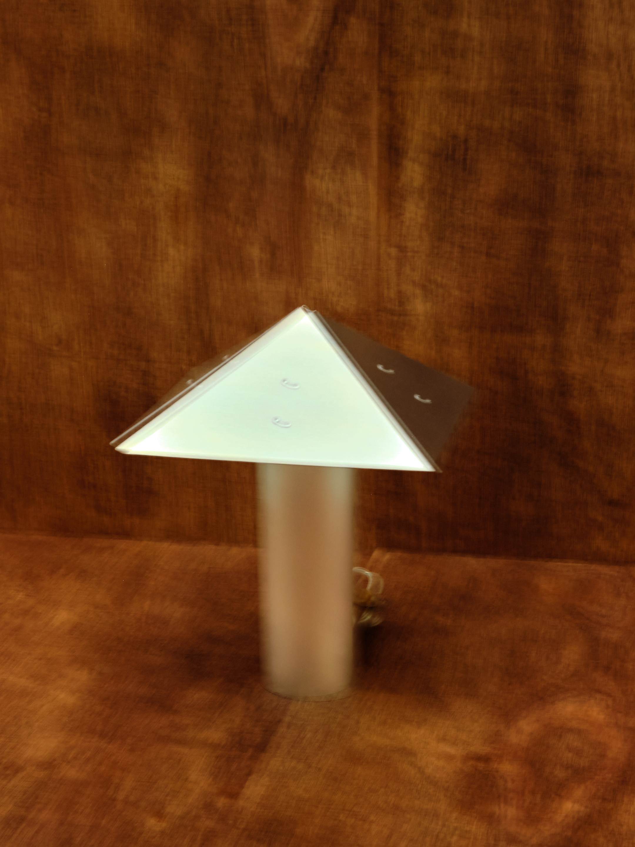 Triangular lamp on a wooden surface