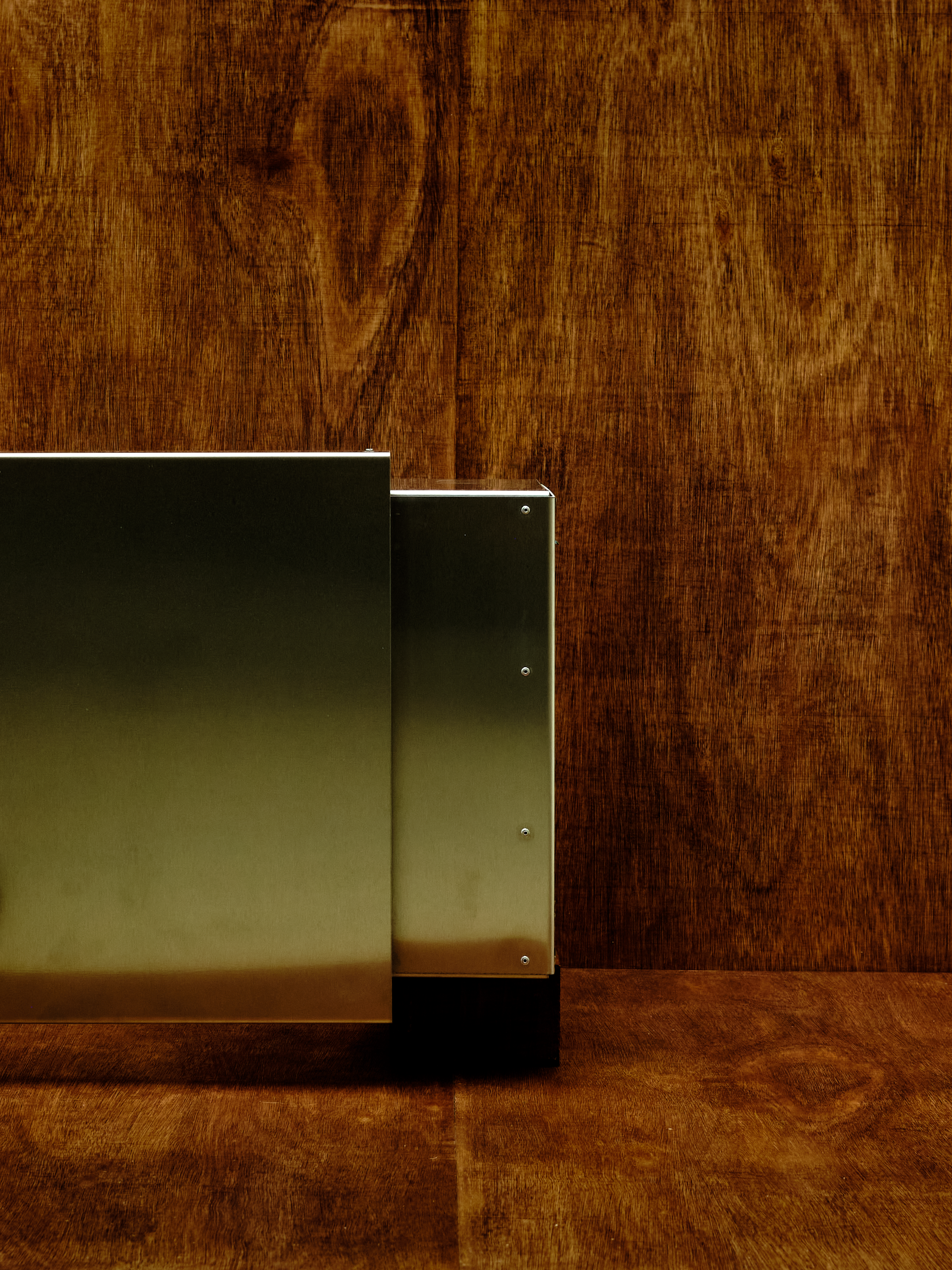 Metallic box on a wooden surface with a wooden background