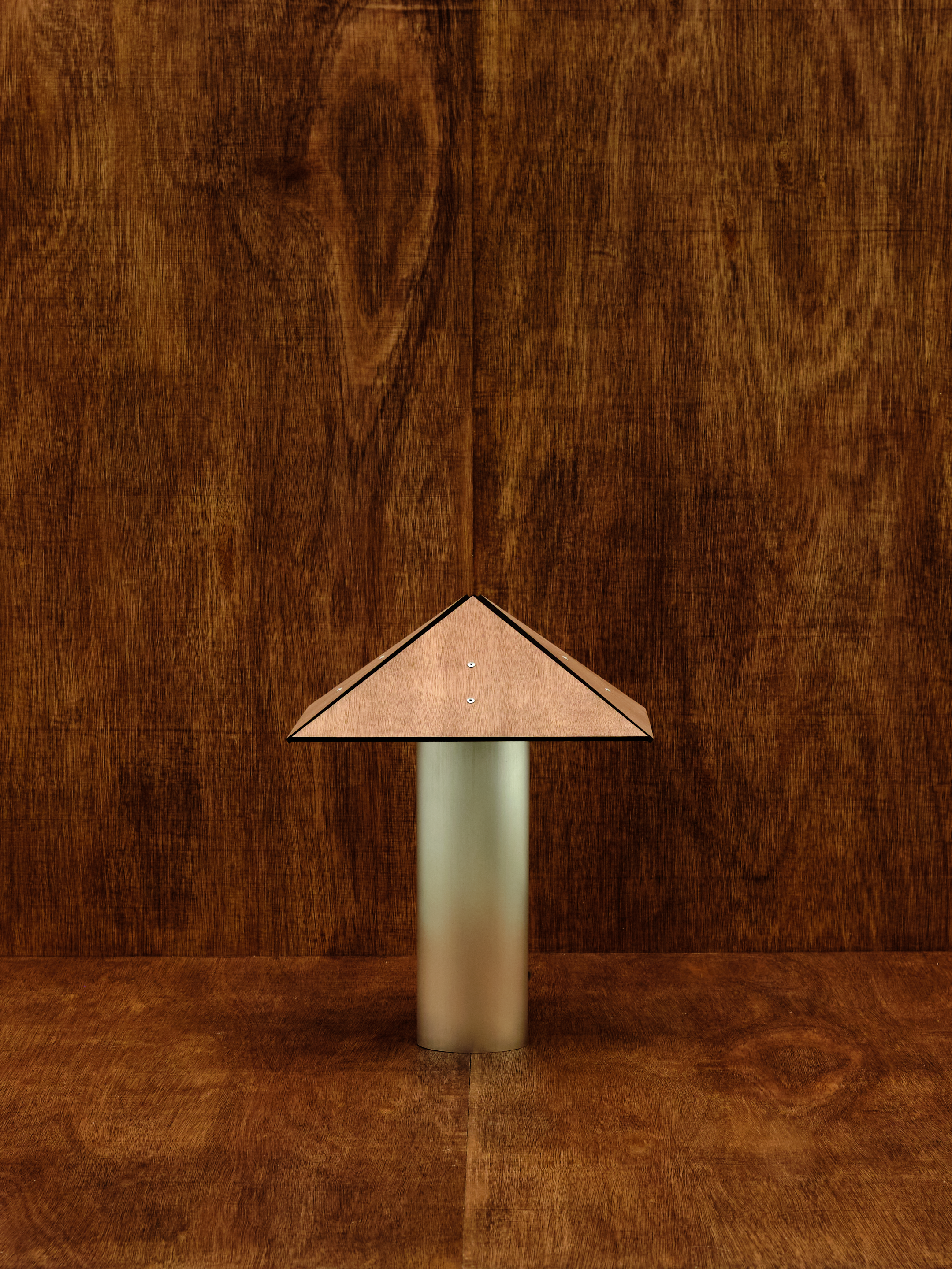 Small lamp with a geometric shade on a wooden surface