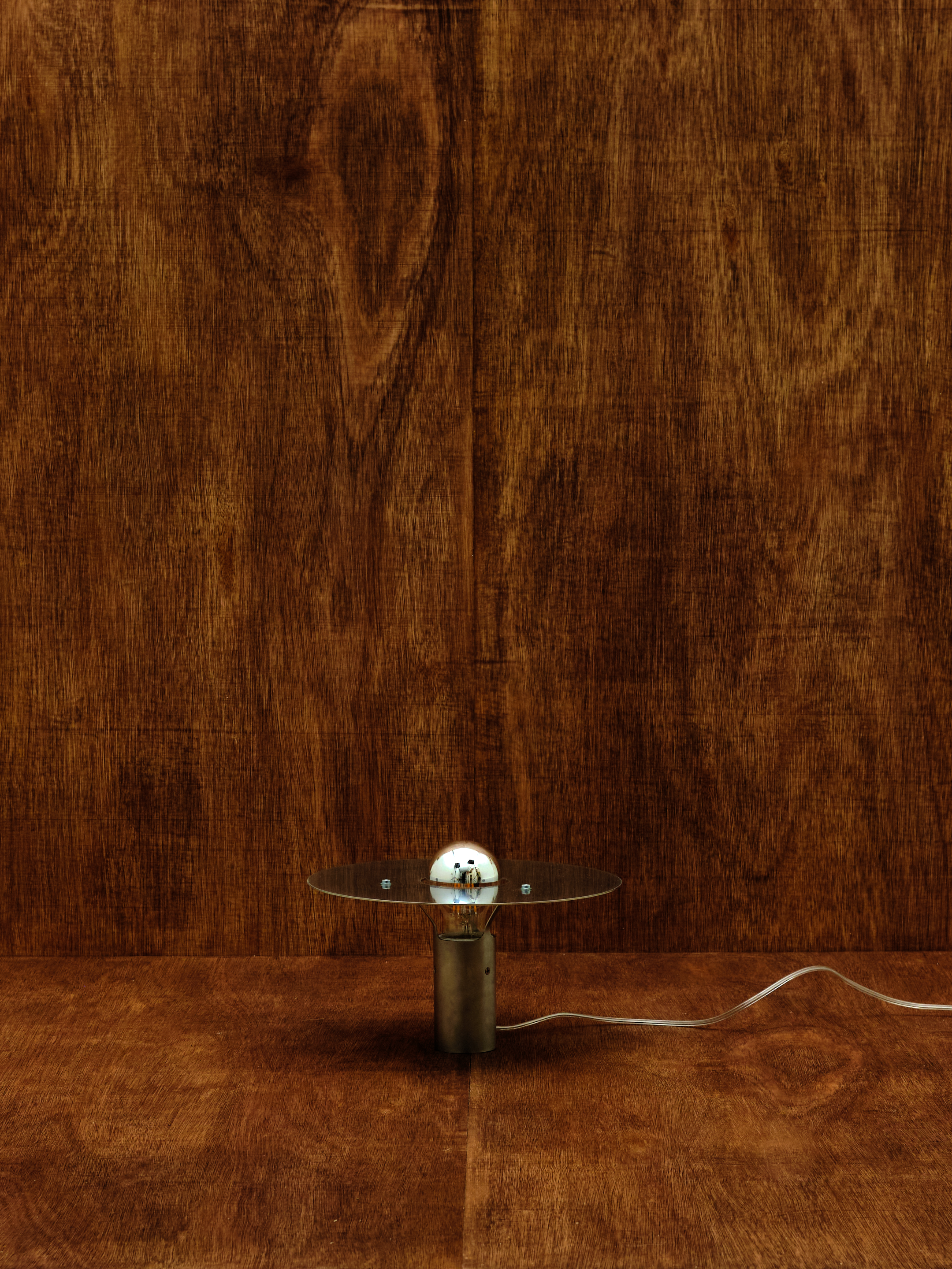 Small round lamp on a wooden background.